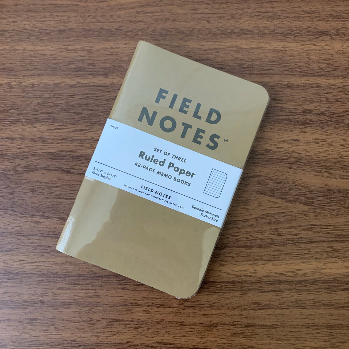 A set of three Field Notes 48 page pocket notebooks with kraft paper covers, ruled.