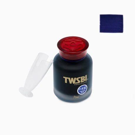 TWSBI Midnight Blue ink bottle with red cap and white cap on a white background