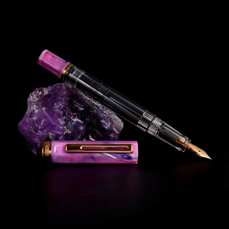 TWSBI ECO Fluorite Purple + Bronze Fountain Pen Uncapped on Fluorite Rock
