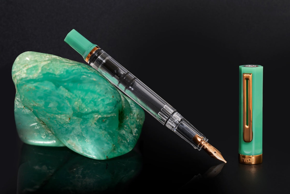 TWSBI ECO Jade Jelly Plus Bronze Fountain Pen uncapped with barrel propped against Jade Rock