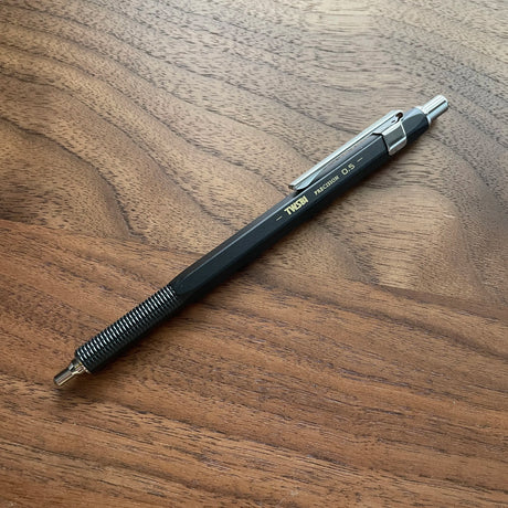 Black TWSBI Precision mechanical pencil Retractable Tip on a wooden surface