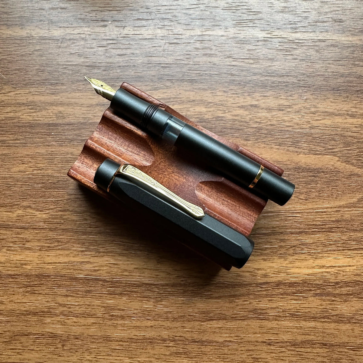 Kaweco AL-Sport Piston Filler (Black) Uncapped on Pen Stand