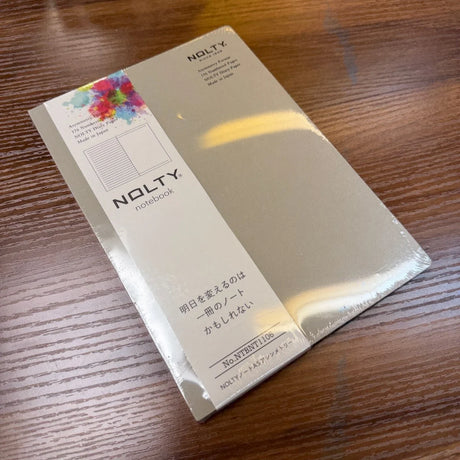 NOLTY A5 Notebook with greige cover and asymmetry (lined on left page, dot grid on right page) layout.