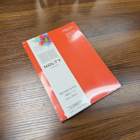 NOLTY A5 Notebook with orange cover and grid layout.