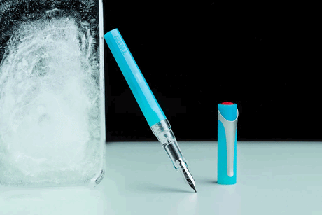 Ice Blue TWSBI Swipe Fountain Pen Uncapped resting against a block of ice