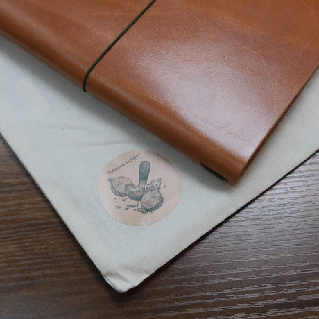 Leather OnionBrand Notebook Cover on table showing logo