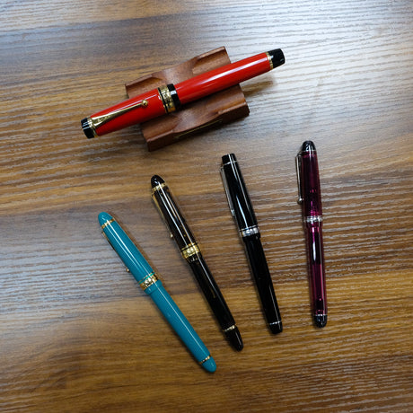 Several Pens Arrayed on Desk