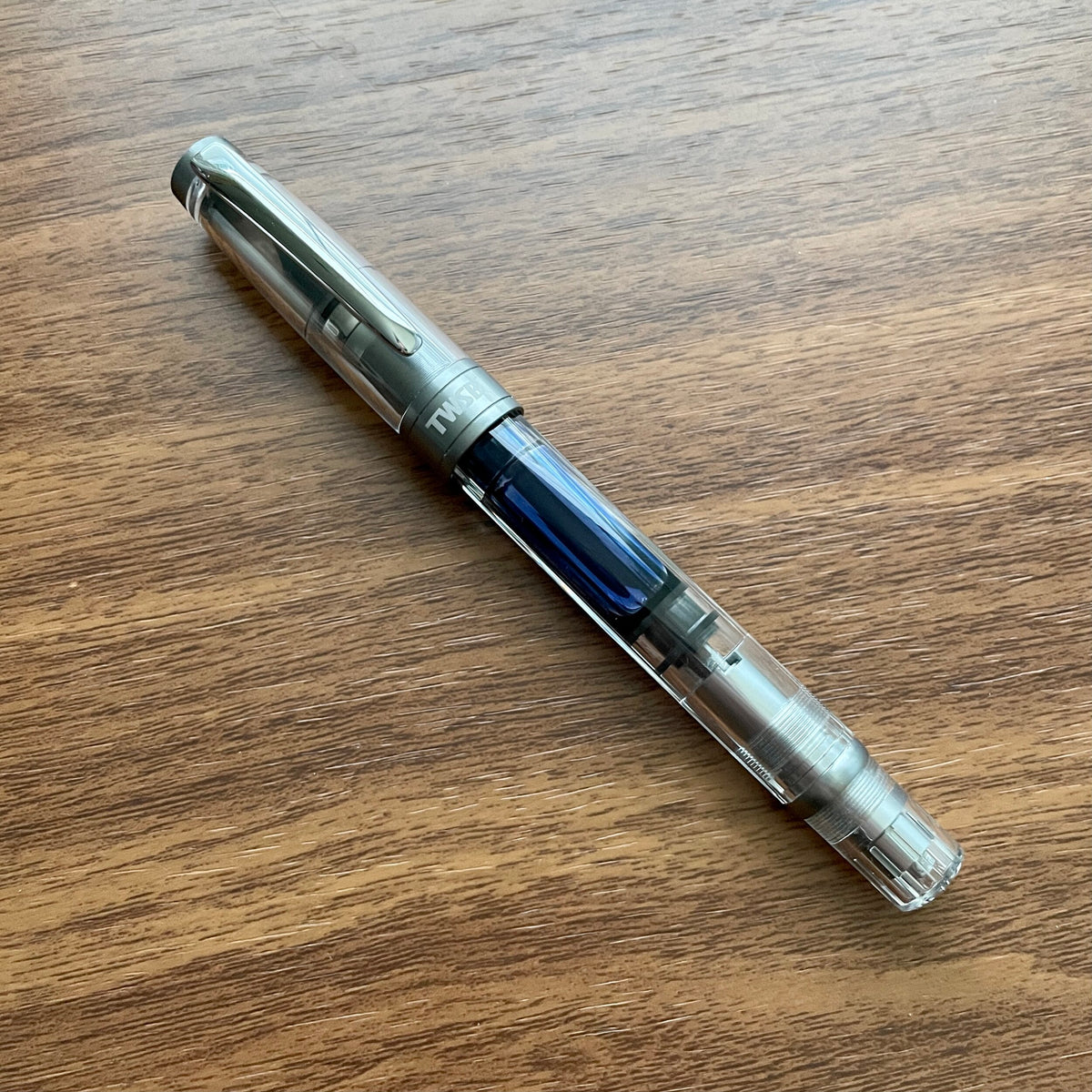 TWSBI Diamond 580 ALR Nickel Fountain Pen Inked on Table