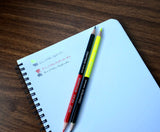 Caran D'Ache Bicolor Black and Yellow Pencil next to red and black pencil