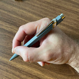 Caran d'Ache 849 Rollerball Pen in Hand