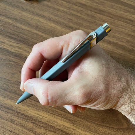 Caran d'Ache 849 Rollerball Pen in Hand