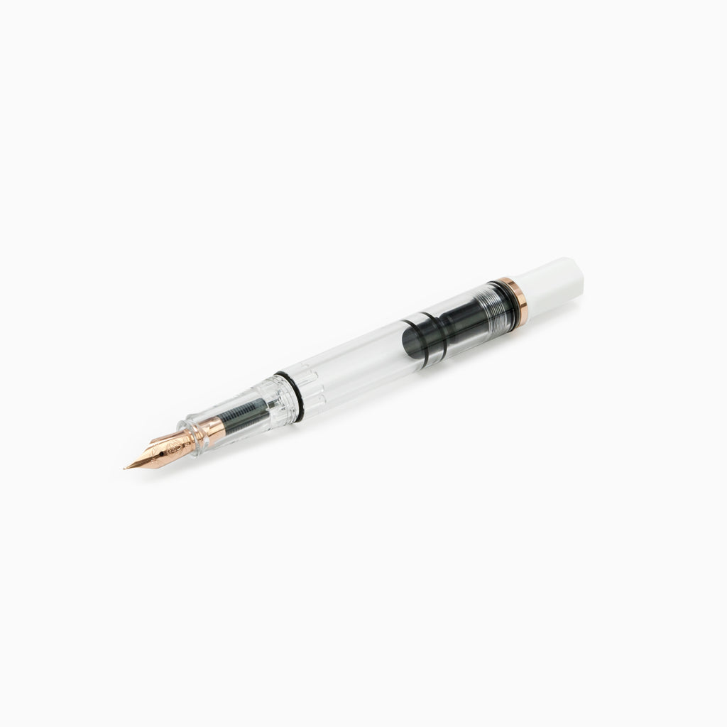 TWSBI White and Rose Gold Fountain pen uncapped sitting diagonally on a white background 