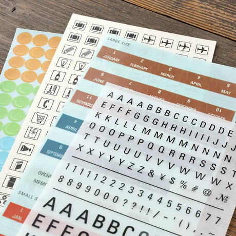 TRAVELER'S Diary 2027 Themed Sticker Sheets with stickers laid out and arrayed on tables