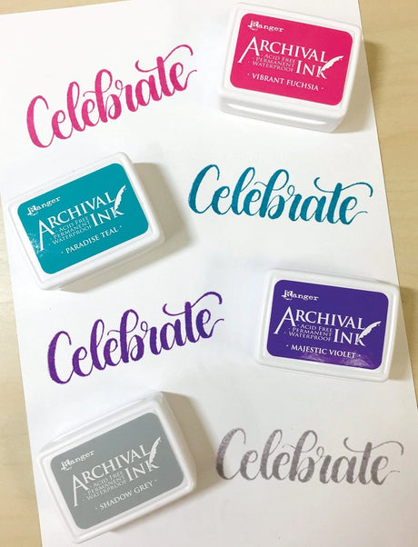 Ranger Ink Archival Mini Stamp Pads with Vibrant Fuschia, Paradise Teal, Majestic Violet and Shadow Grey inks Shown with Ink samples on white paper