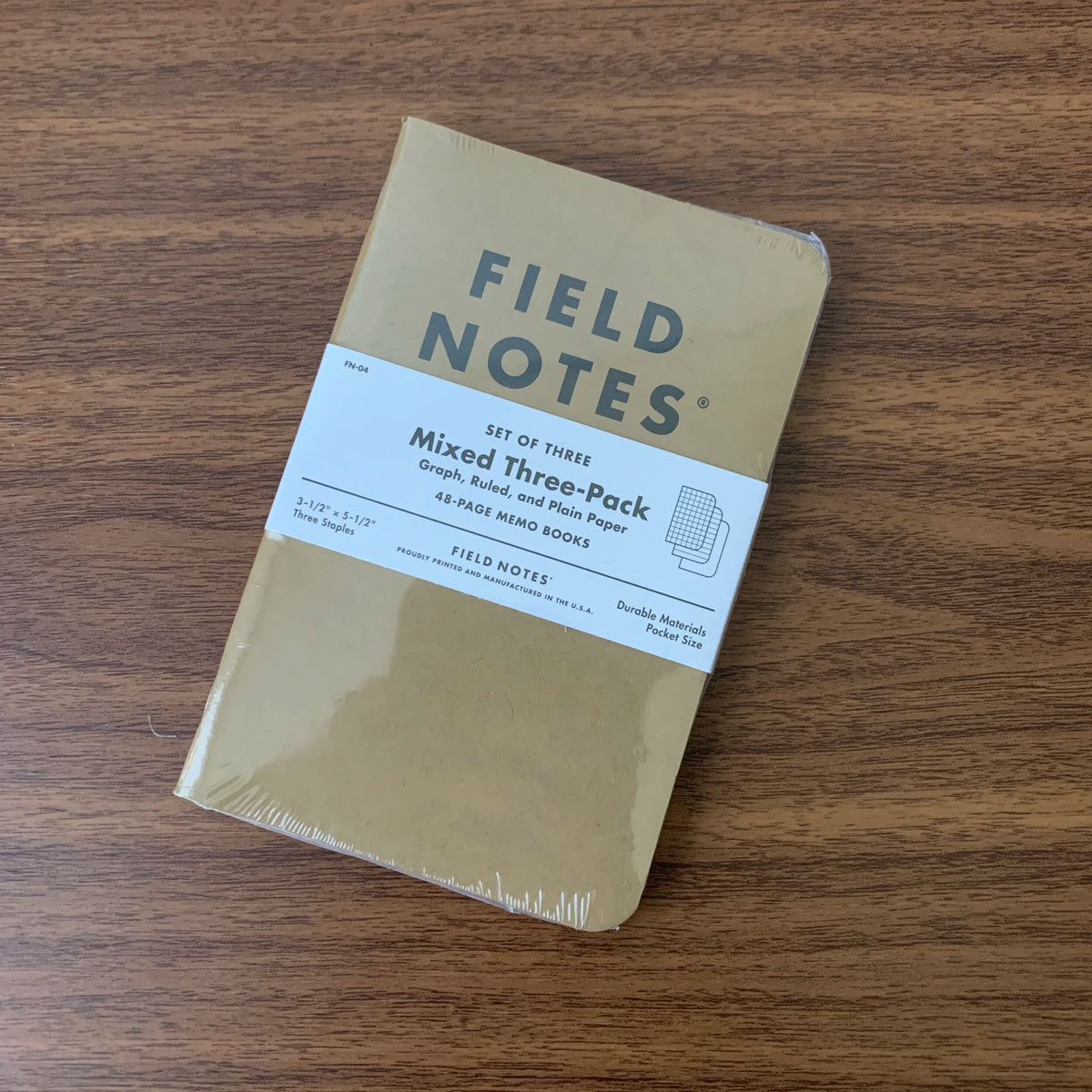 A set of three Field Notes 48 page pocket notebooks with kraft paper covers, Mixed Three-Pack with Graph, Ruled, and Plain rulings.