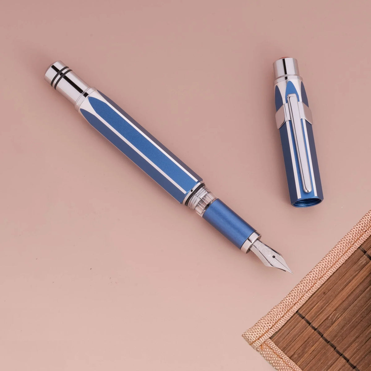 Gemini Blue TWSBI Precision fountain pen with cap on a beige background