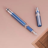 Gemini Blue TWSBI Precision fountain pen with cap on a beige background