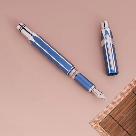 Gemini Blue TWSBI Precision fountain pen with cap on a beige background
