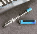 TWSBI Cosmo Blue + Onyx Fountain Pen on Gray Background