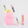 TWSBI ECO Pink Lemonade Uncapped Next to Drink