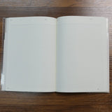 Open NOLTY A5 Notebook with white grid pages and headers for title and date.