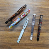 Opus 88 Harmony Fountain Pens displayed on wood table on pen stands