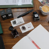 TGS x Tono & Lims 12th Anniversary Inks on Desk with Pens and Coffee