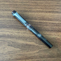 TWSBI Swipe Smoke Fountain Pen Resting on Wood Desk