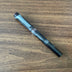TWSBI Swipe Smoke Fountain Pen Resting on Wood Desk