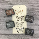 Ranger Ink Mini Stamp Pad 4-pack featuring Tim Holz Distress Inks Showing Vintage Photo, Ground Espresso, Hickory Smoke, and Black Soot ink samples on paper