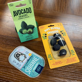 Fred & Friends Food Erasers Three Different Types (Avocado, Olives, and Sardines) shown together on a wood tabletop