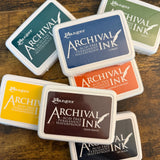 Ranger Ink Archival Ink Pads fanned on table in multiple colors