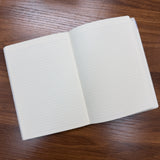 Midori B6 Gradation Day Length Planner open to blank notes pages showing lined midori paper