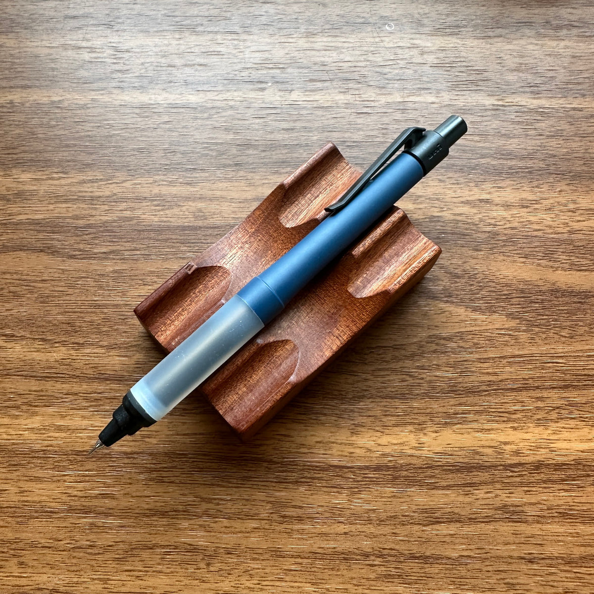 Uni Kuru Toga Alpha Gel Switch Mechanical Pencil in navy blue with black trim and clear gel grip.