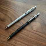 Two TWSBI Precision Ballpoints on a wooden surface