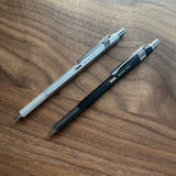 Two TWSBI Precision mechanical pencils on a wooden surface