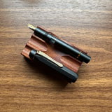 Kaweco AL-Sport Piston Filler (Black) Uncapped on Pen Stand