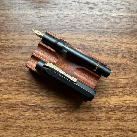 Kaweco AL-Sport Piston Filler (Black) Uncapped on Pen Stand