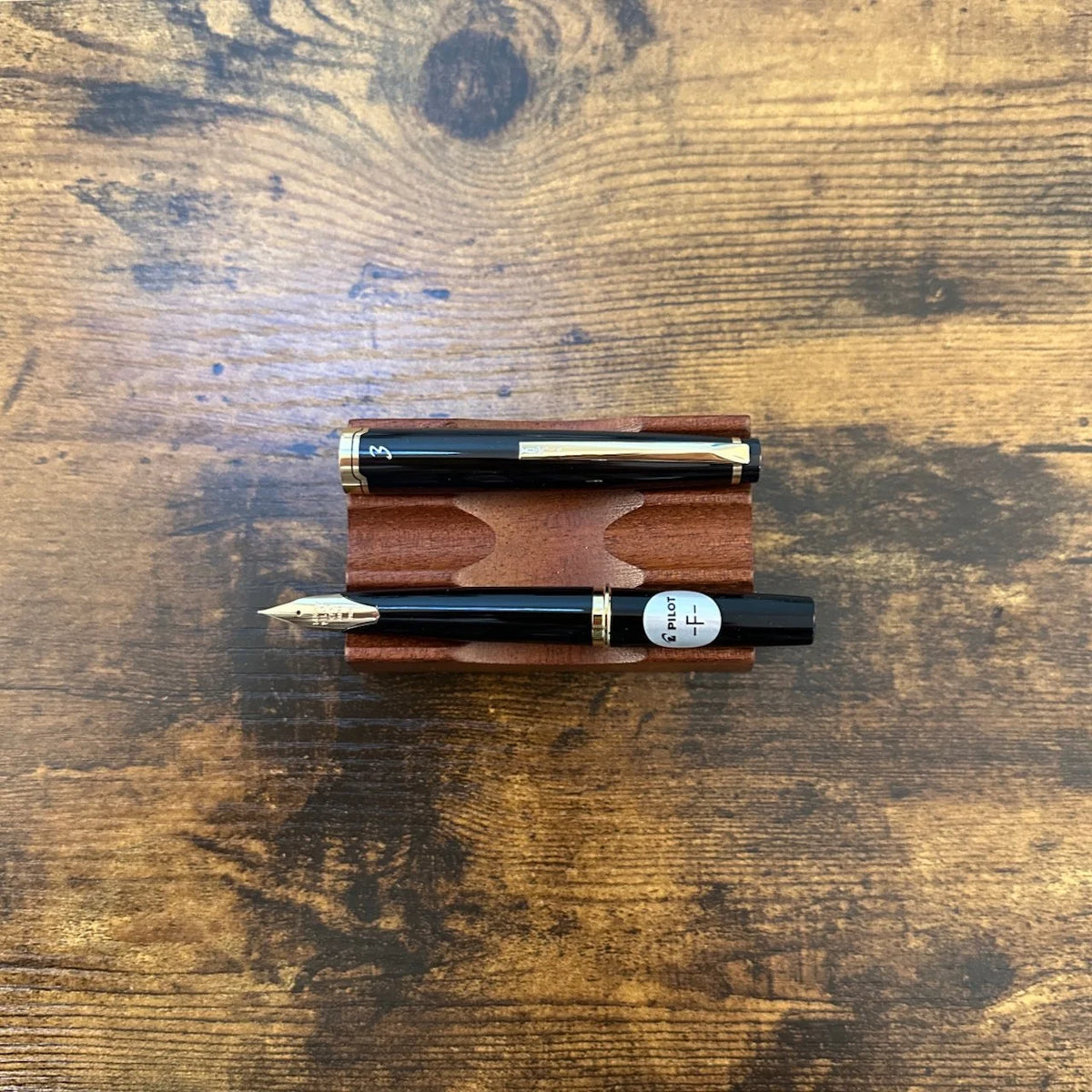 Pilot E95S Fountain Pens Black Uncapped Horizontal on Pen Stand