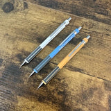 Three TWSBI Pagoda mechanical pencils on a wooden surface