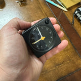 Braun Small Travel Alarm Clock Black in hand for scale