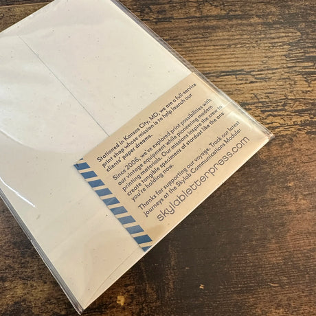 Back of package of letterpress greeting cards with information on the label about skylabletterpress.com.