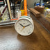 Braun Round Travel Alarm Clock on Desk