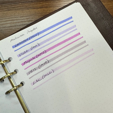 A close-up of Zebra Mildliner highligher color swatches for Lavender, Violet, Magenta, Iris, and Lilac.