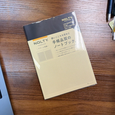 NOLTY A5 Notebook with black cover and 96 ivory grid pages.