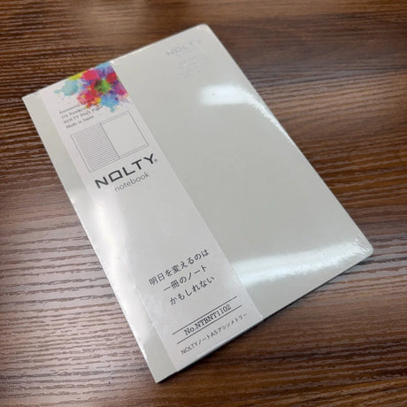 NOLTY A5 Notebook with light gray cover and asymmetry (lined on left page, dot grid on right page) layout.
