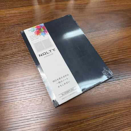 NOLTY A5 Notebook with black cover and grid layout.