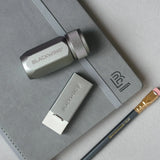 Blackwing Handheld Eraser Grey on table with sharpener and pencil