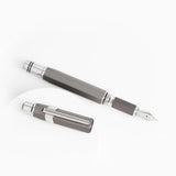Gunmetal Grey TWSBI Precision fountain pen with silver accents on a white background