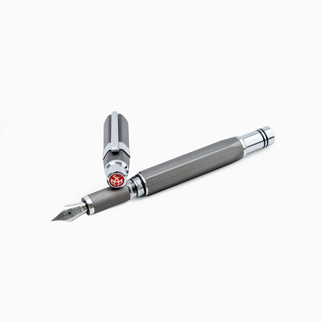Gunmetal Grey TWSBI Precision fountain pen on a white background uncapped with cap resting on section